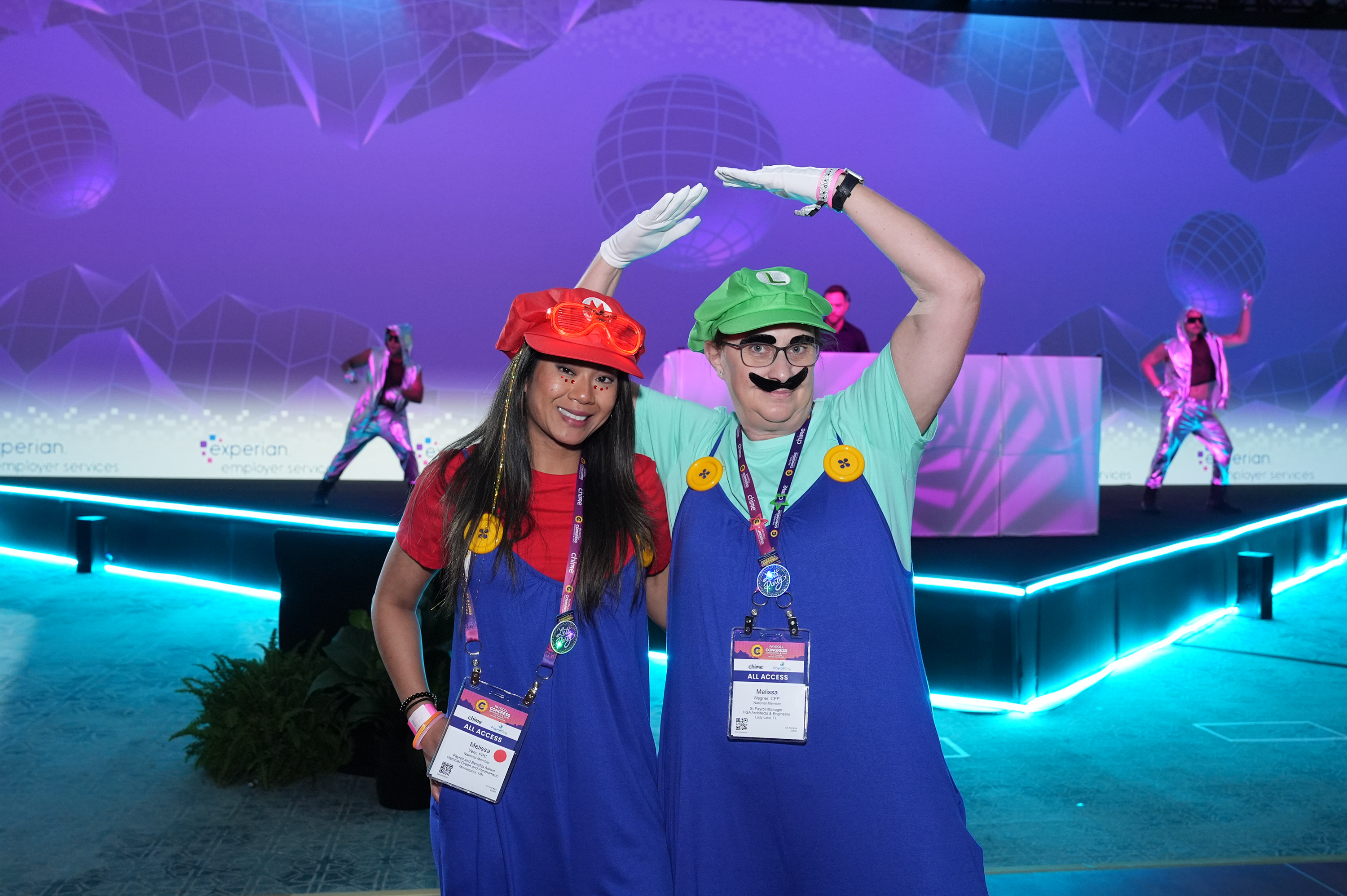 Photo from the 2025 Payroll Congress Party showing people dancing in Mario Bros. costumes.