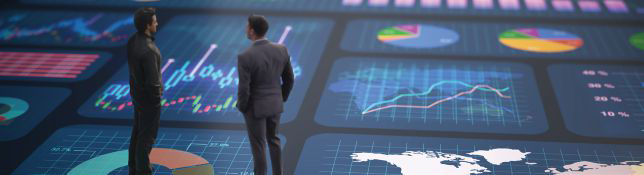 Two people stand in front of a large digital dashboard filled with charts, graphs, and data visualizations.