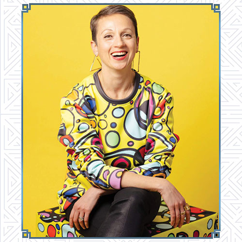 Keynote Speaker Nataly Kogan against a yellow backdrop.