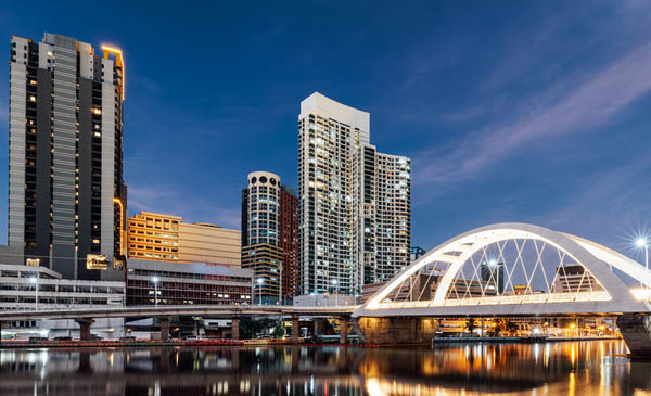 Manila City skyline during sunset with a bridge connecting Intramuros to Binondo