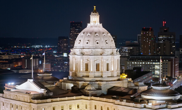 Nighttime view of the Minnesota state capitol building and the surrounding city.