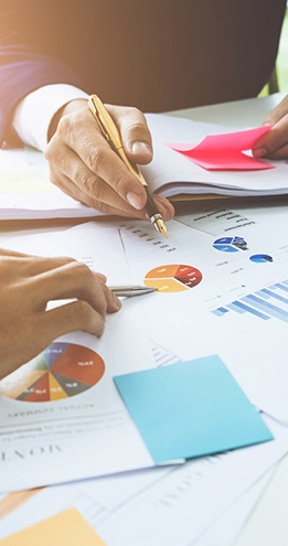 Office workers pore over documents, symbolizing the complexity of global payroll.