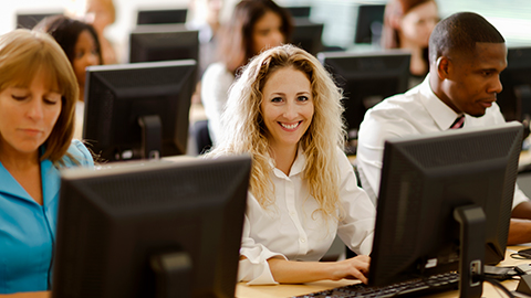 woman at computer smiling woman at computer smiling