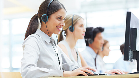 Hotline employees typing on computers
